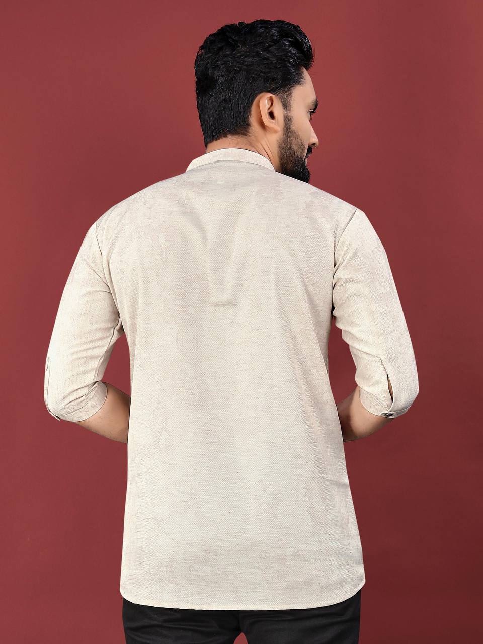 Back view of man wearing beige desert bloom short kurta with rolled-up sleeves by Pehrang