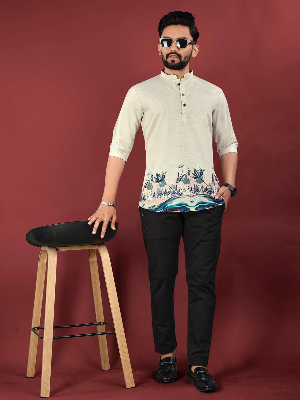 Man wearing beige Pehrang desert bloom short kurta with floral design and black pants