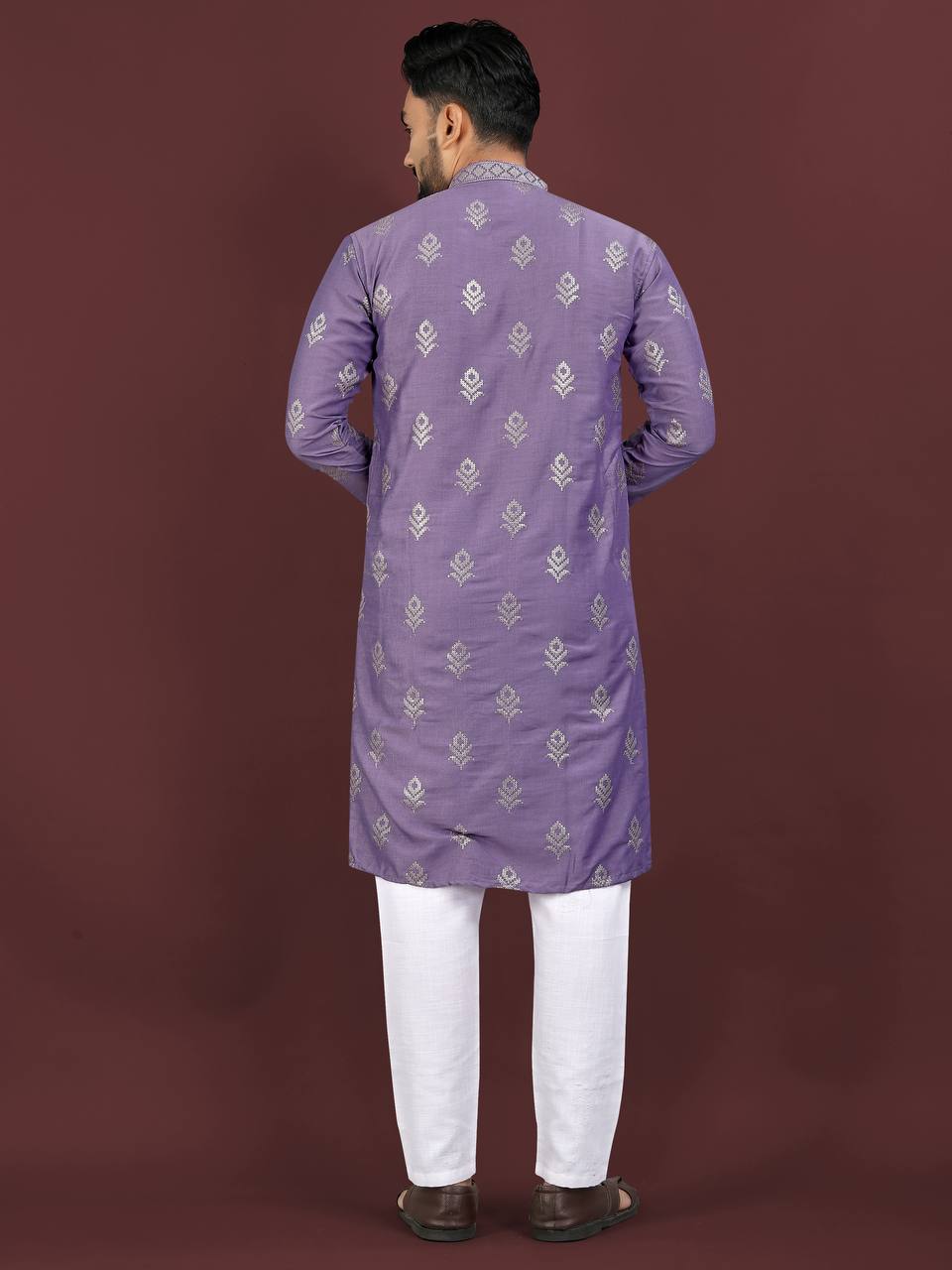 Back view of man wearing lavender jacquard kurta set with white pants and brown shoes by Pehrang
