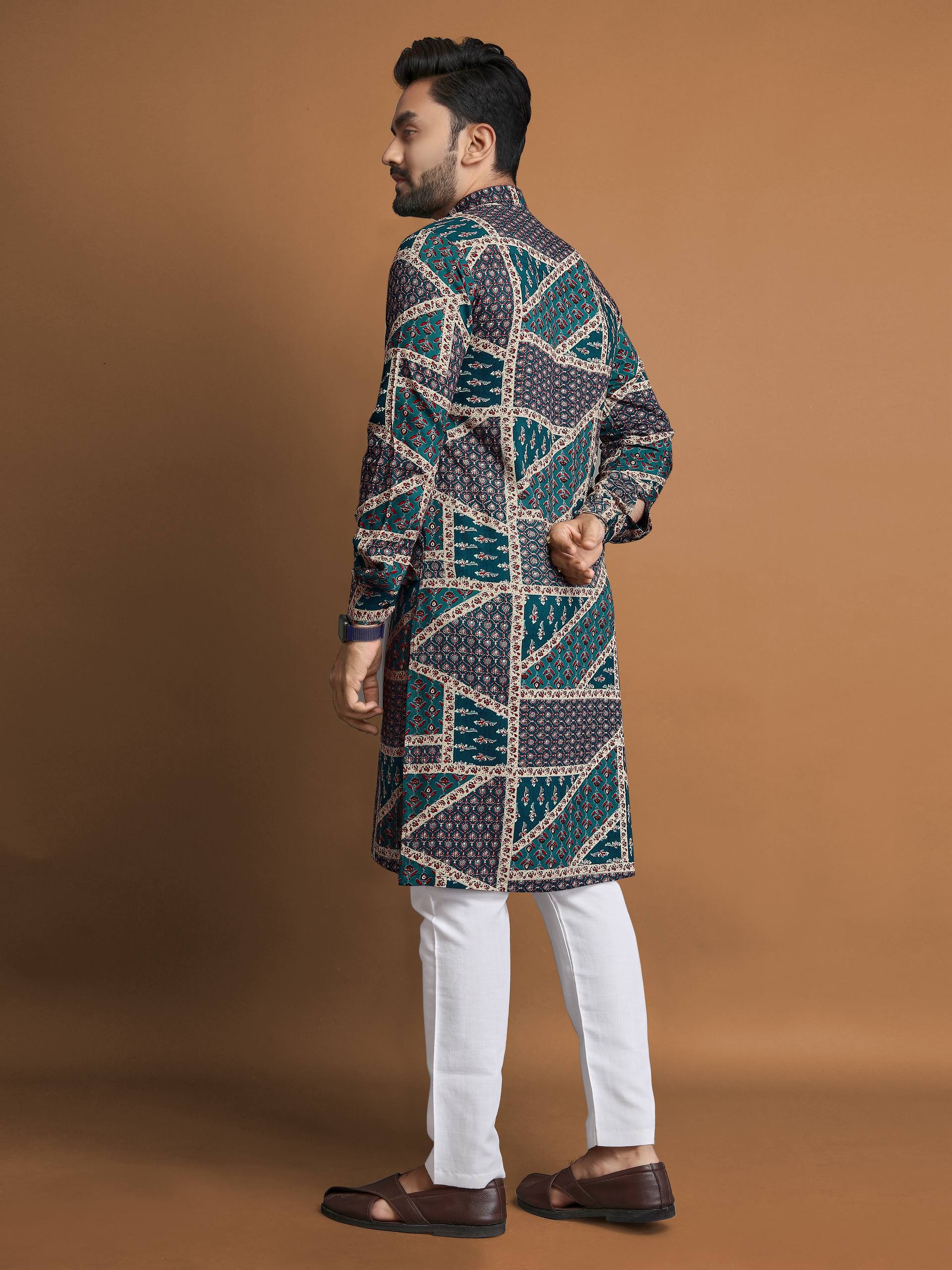 Man wearing men's cotton foil print kurta with geometric patterns paired with white pants and brown shoes
