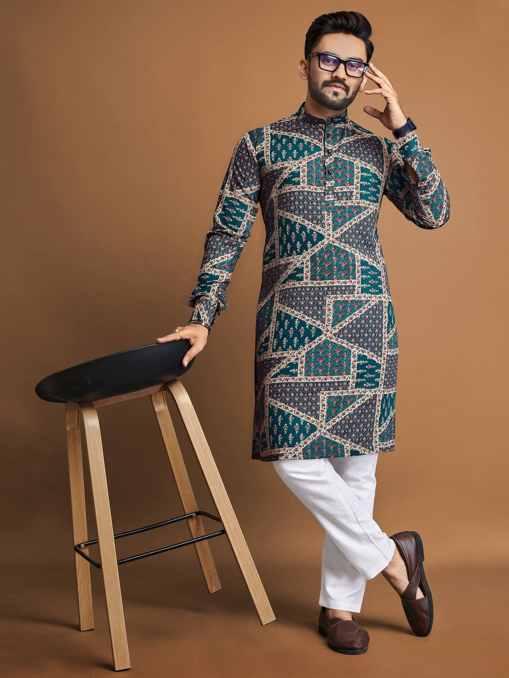 Man wearing men's cotton foil print kurta with geometric patterns paired with white pants and brown shoes