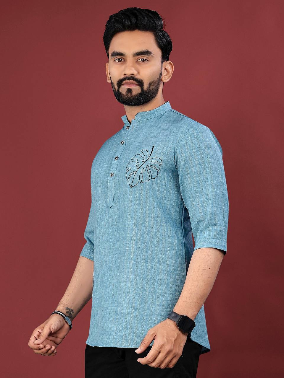 Man wearing a blue ocean leaf embroidered kurta with three-quarter sleeves and mandarin collar